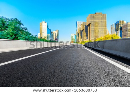 Empty asphalt road and modern cityscape in Beijing,China.
