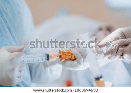 preparation of fat cells for lipofilling in the operating room. Surgical cosmetic surgery to rejuvenate the face with the introduction of stem and fat cells. Royalty-Free Stock Photo #1863694630