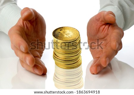 Business men holding a pile bitcoins between hands on white