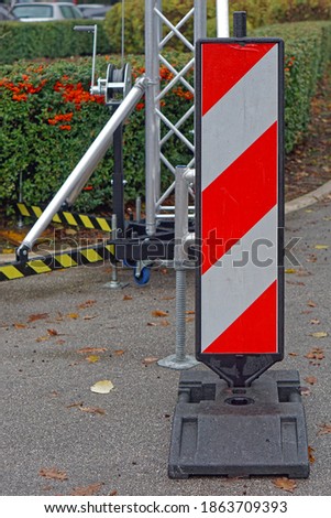Red and white stripped caution warning sign