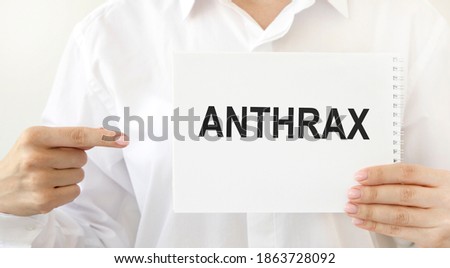 The doctor points to a notepad with the text of ANTHRAX.
