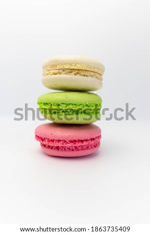 Macaroons isolated on the white background.Homemade french style colorful macaroons. Green, white, pink cookies.