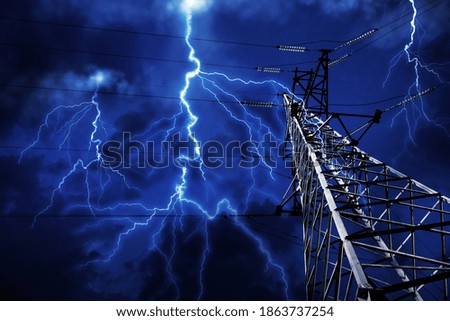 Picturesque lightning storm over high voltage tower, low angle view