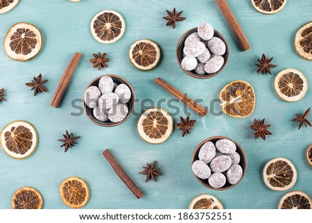 Spiced almonds with chocolate powder, traditional german christmas sweets called Gewürzmandeln with spices like cinnamon, anise, winter season