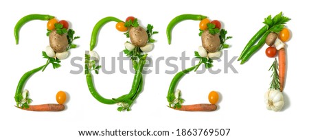 Number 2021 and healthy written with vegetables, concept for healthy food, living, covid 19, coronavirus prevention. Isolated on white background. Happy new year. End of the year resolution Royalty-Free Stock Photo #1863769507