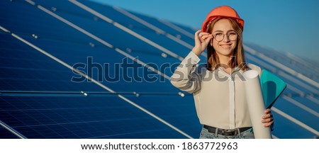 Businesswomen working on checking equipment at solar power plant with tablet checklist, woman working on outdoor at solar power plant. Royalty-Free Stock Photo #1863772963