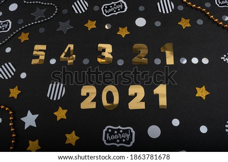 Countdown for New Year 2021. Golden numbers and confetti on black background