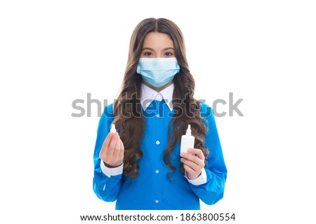 girl hold medicine nasal spray drug from running nose wearing protective medical mask isolated on white, coronavirus.