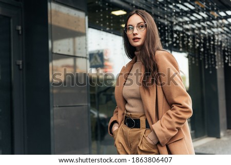 Fashion editorial style pictures of a beautiful girl exploring the raw spaces of a city. Female fashion concept.