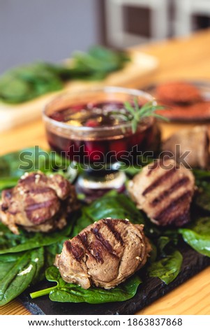 meat with fresh herbs and cherry sauce, ready to eat.