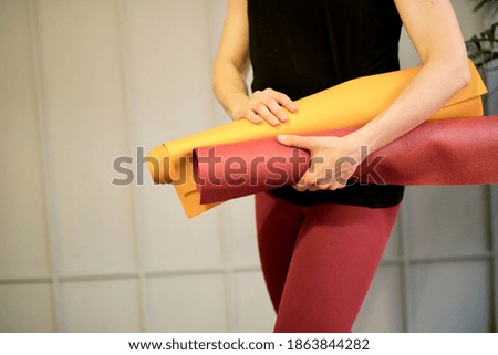 Young woman holding a yoga mat. woman practicing yoga concept natural balance between body and mental development.