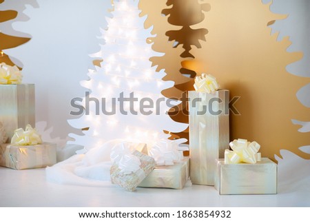 Big Christmas stars are decorated with golden balls and garlands. Decorative wooden Christmas tree Christmas gold and white on a white background