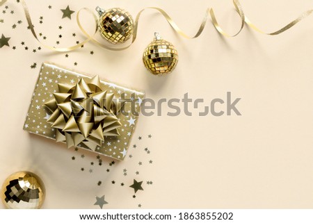 Greeting card concept voor Christmas New Year on Set Sail Champagne color background.Trendy color of the year.Gold effect sparkle texture traditional decoration for the holiday.Copy space.