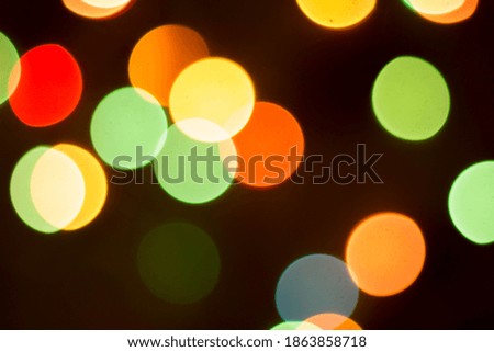 Blurred multicolored lights on a dark background. Background. A photo.