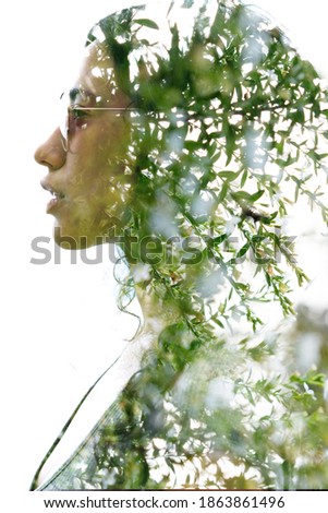 A portrait of a young woman's profile with sun glasses against white background combined with a photo in a double exposure technique