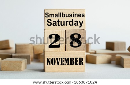 SMALLBUSINESS SATURDAY is written on wooden cubes stacked in the form of a mobile calendar.
