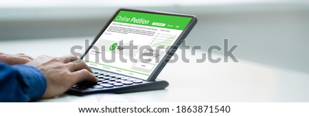 Man Signing Online Petition Application Form On Tablet