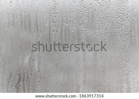 Dripping Condensation, Water Drops Background Rain drop Condensation Texture. Close up for misted glass with droplets of water draining down  Royalty-Free Stock Photo #1863917314