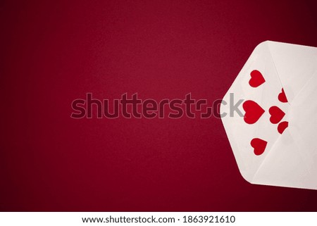 Envelope with hearts on red background. Romance and love concept.vertical