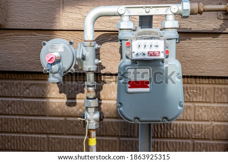 residential gas meter and pressure regulator Royalty-Free Stock Photo #1863925315