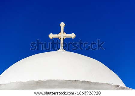 Dome of a church with a cross on a Greek island