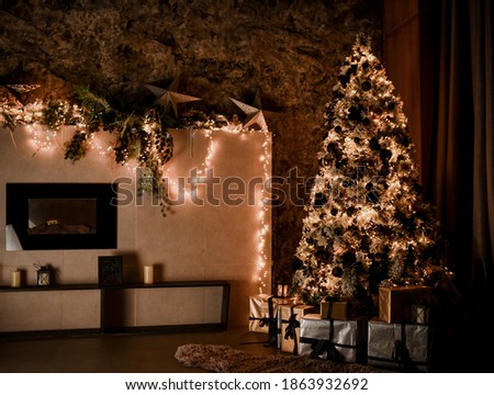 Christmas, New Year interior with loft design home decorated fir tree with garlands, balls and gift present boxes at evening dinner on dark background