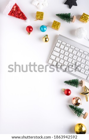 Creative layout made of Christmas bauble decoration and keyboard. Flat lay. Holiday background