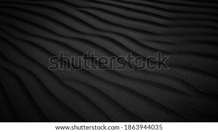 Black Sand dune. Black Sand beach macro photography. Background, texture, wave pattern of oceanic sand on the beach, black. Texture of beach sand. Black beach. Royalty-Free Stock Photo #1863944035