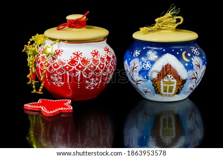 Christmas set with painted pots and wooden ornaments in red, on a black background