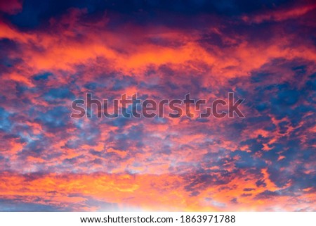 a bright beautiful sun set cloudscape with bright orange  , pink and blue colors
