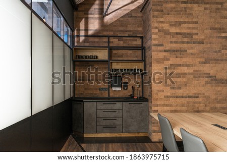 View of the cupboard and shelves at the modern office loft interior. A lot of wooden textures and contemporary design of office. Stock photo