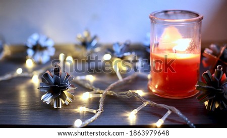 Close up picture of Christmas ornaments with lights and candle