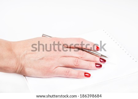 woman's hand with pen writting in notebook