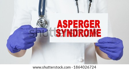 Medicine and health concept. The doctor points his finger at a sign that says - ASPERGER SYNDROME