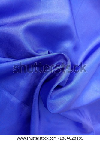 Blue cloth sleek and shiny.
 satin fabric texture with crumpled surface.  dark blue color