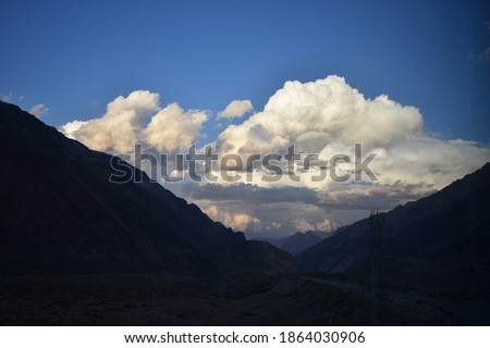 Lighted night clouds behind the mountains