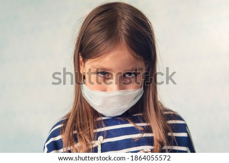 child girl in a medical mask. Sad eyes of a girl. . Children in quarantine at home. an unhappy sick girl is sad in self-isolation.