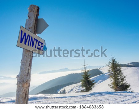 Winter sign high in the mountains. Beginning of winter season concept
