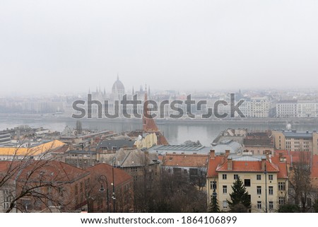 Panoramic picture of Budapest downtown and the Danube river and a bridge on a foggy winter day