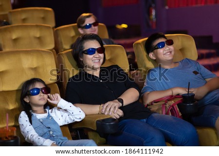 Happy family watching movie in cinema theatre. Happy family time in holiday