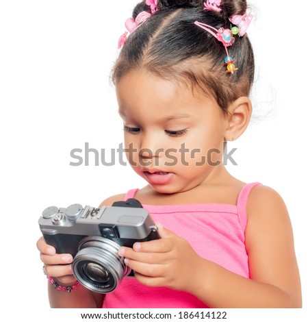 Multiracial small girl holding a compact camera isolated on white