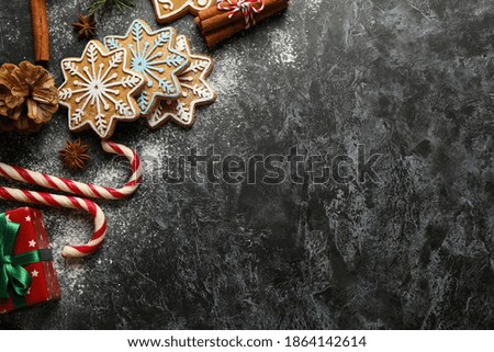 Concept of Christmas food with tasty cookie on black smokey background