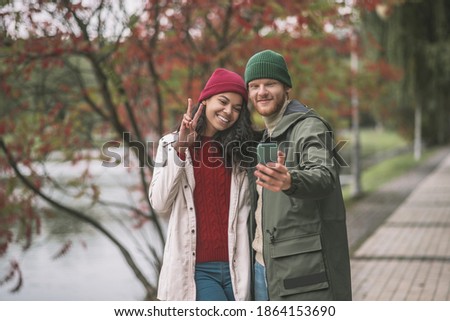 Pictures fo social media. Man and woman making autumn selfie together