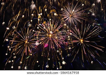 Beautiful Holiday background of fireworks. Fireworks explode in night sky closeup. Texture to design Greeting card for holidays: Christmas, New year, anniversary, independence day, Birthday