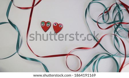 heart with eyes on a background with ribbons
