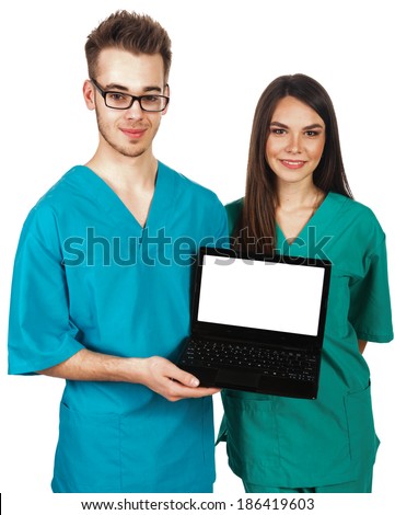 young male and female doctors (nurses, students) holing a laptop 