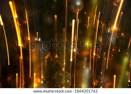 Abstract background of bright colored dynamic lights against the background of christmas decorations