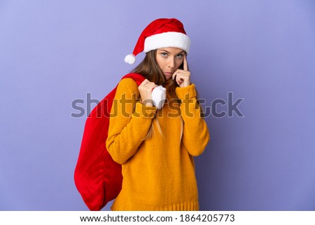 Lithianian woman with christmas hat isolated on purple background thinking an idea