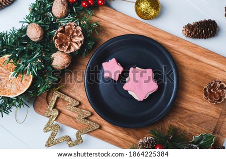 Christmas composition. Festive cookies in star shape on wooden background.