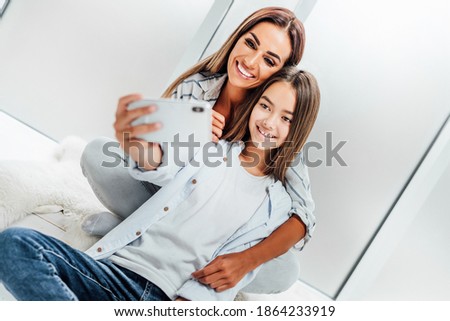 Selfie. Happy daughter taking a selfie with her smiling mother.